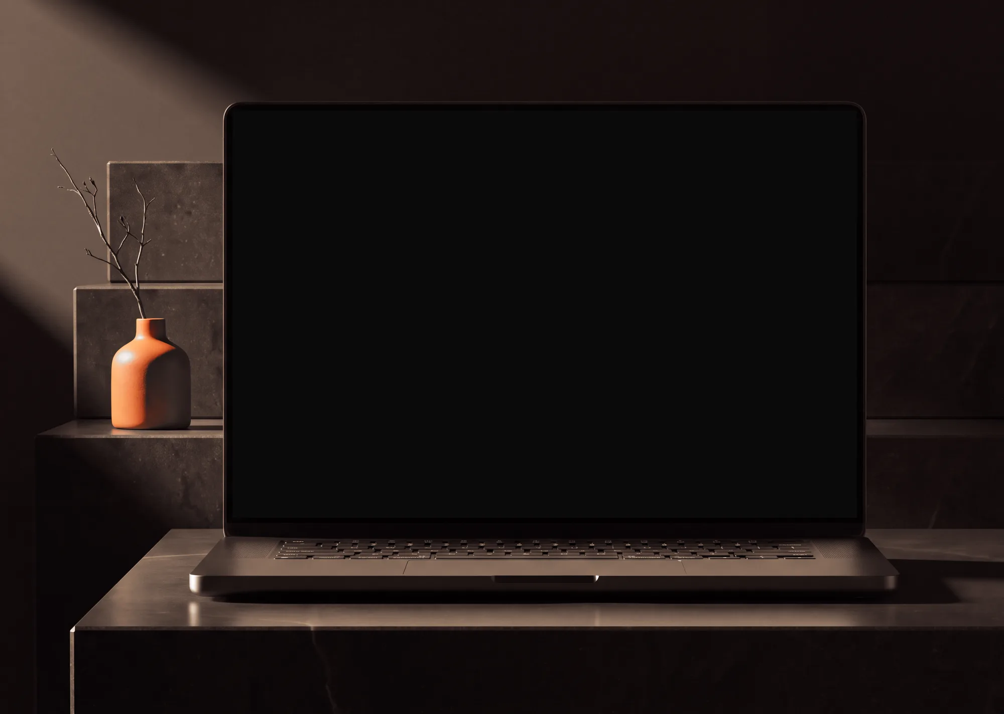 Laptop on a black basalt slab in a dark room