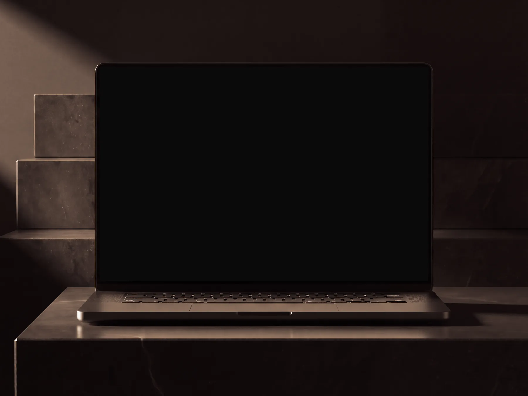 Laptop on a black basalt slab in a dark room