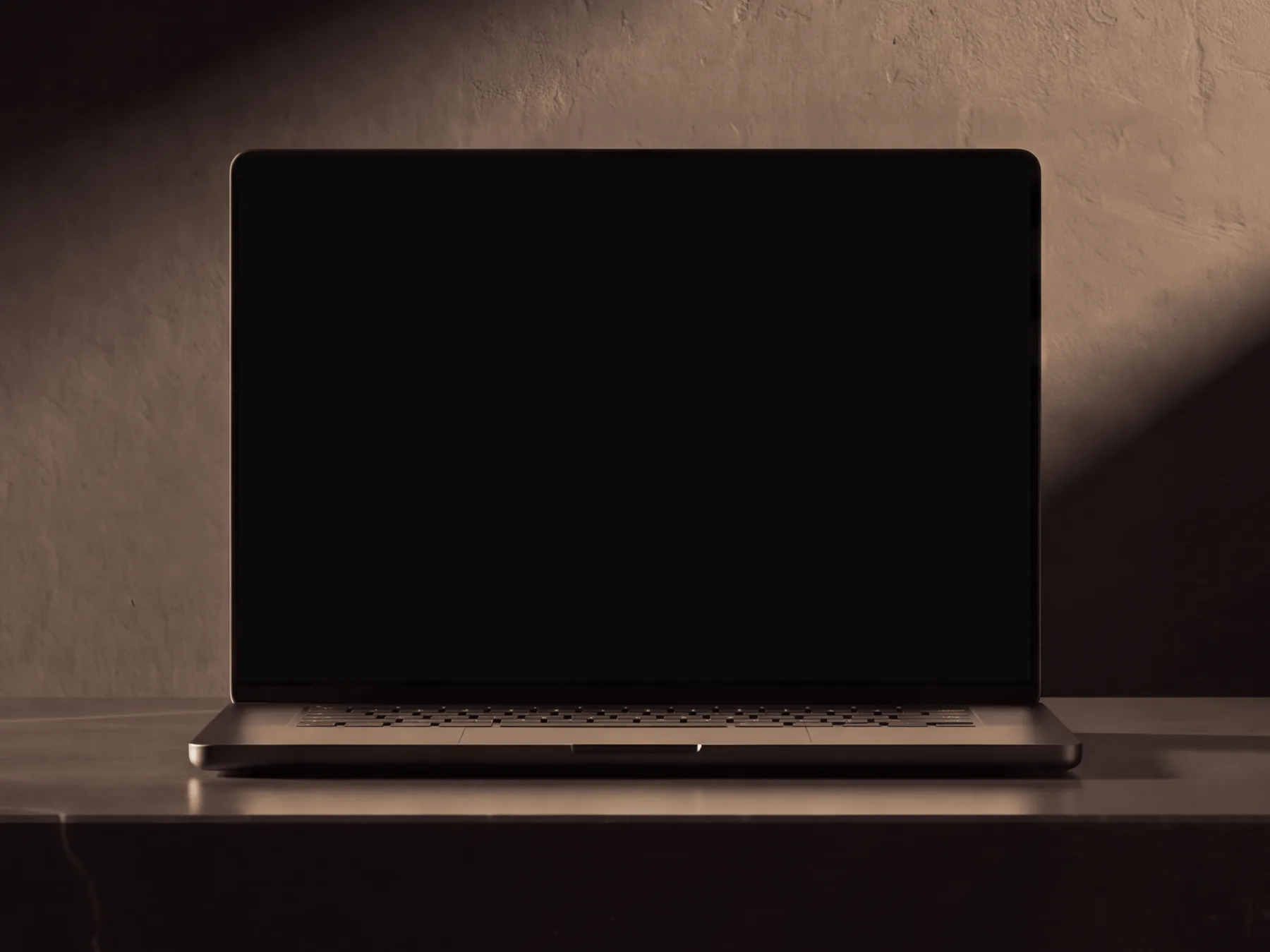 Laptop on a black basalt slab in a dark room