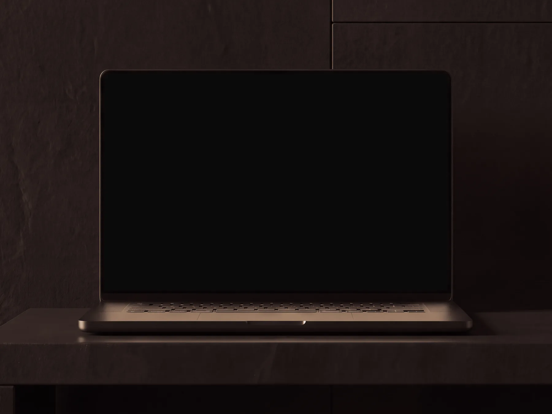 Laptop on a black basalt slab in a dark room