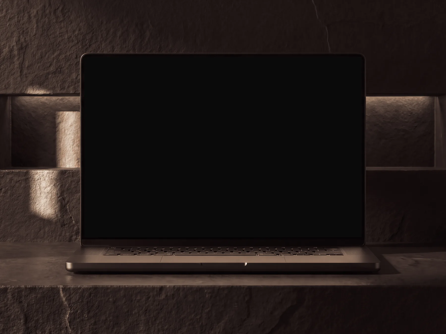 Laptop on a black basalt slab in a dark room